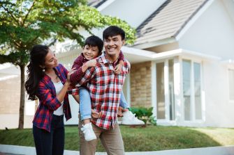 Family walking in front of home